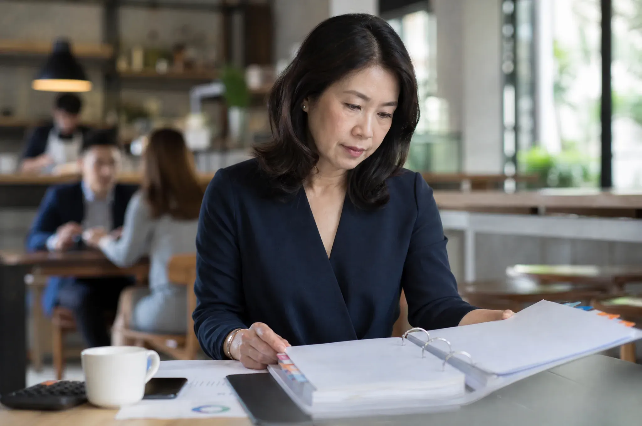 A fractional CFO working through a tabbed client binder