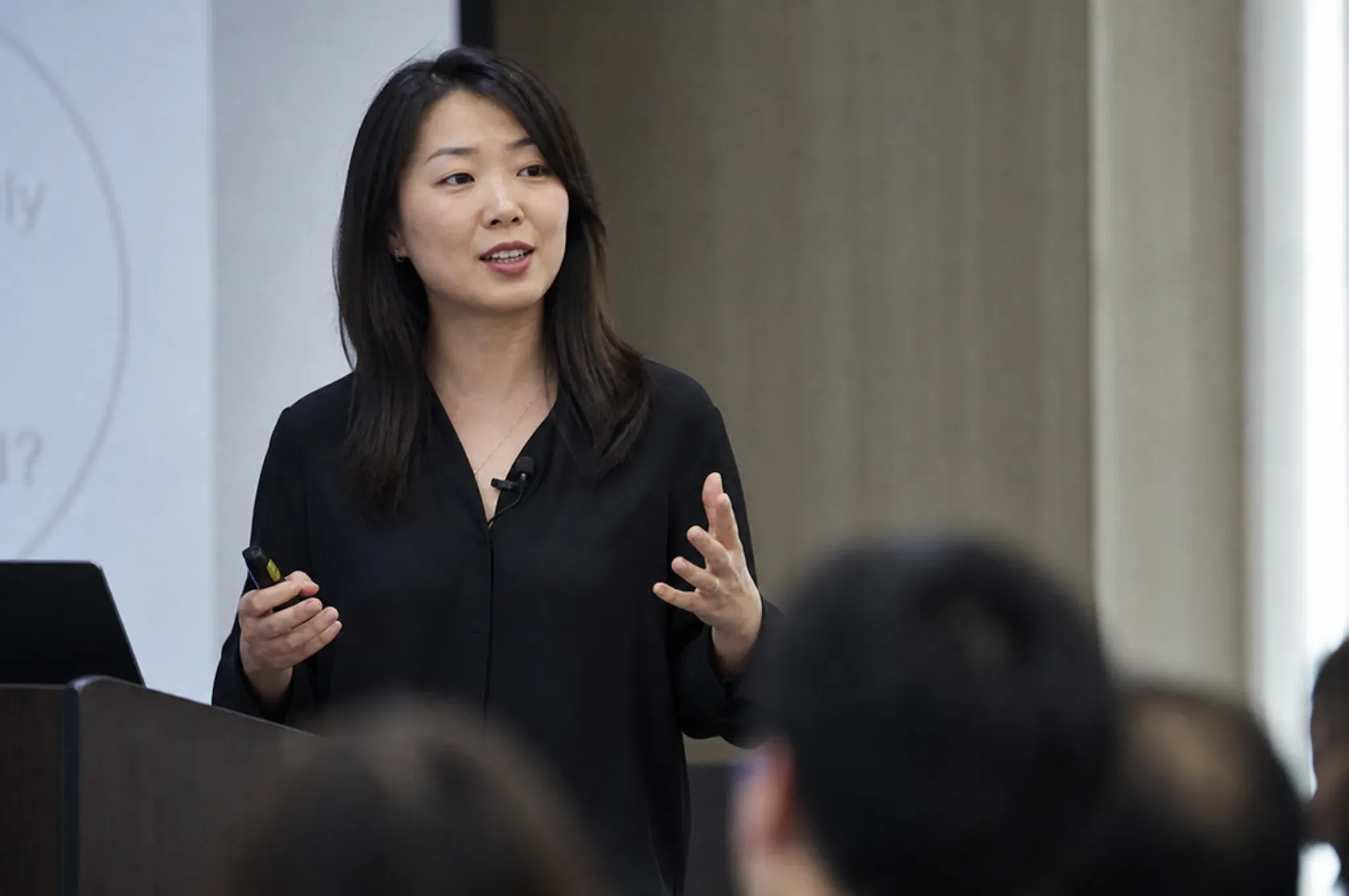 A programme lead presenting to a seated cohort of founders